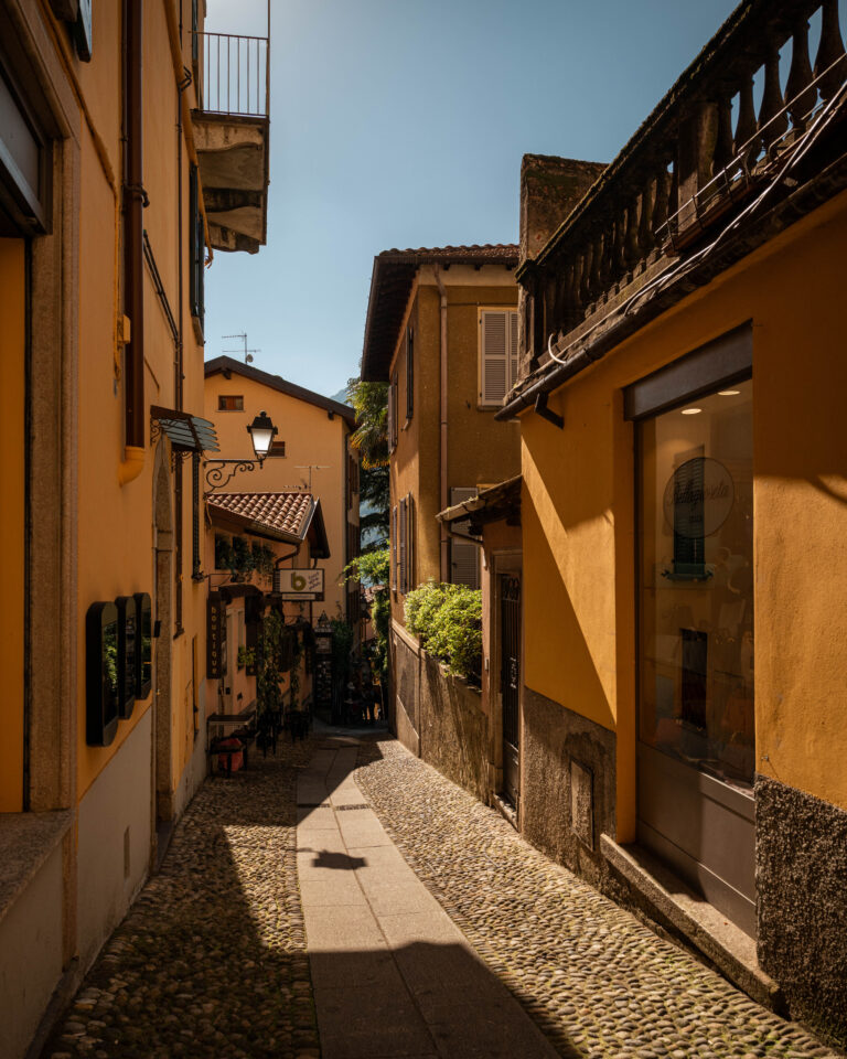 heart of Bellagio, on the shores of Lake Como, narrow alleyway bathes in the soft afternoon sun.