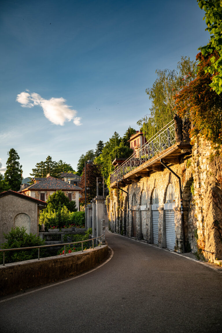 golden light of early evening, this peaceful scene winds through a quiet residential street in Como, on the shores of Lake Como, Italy