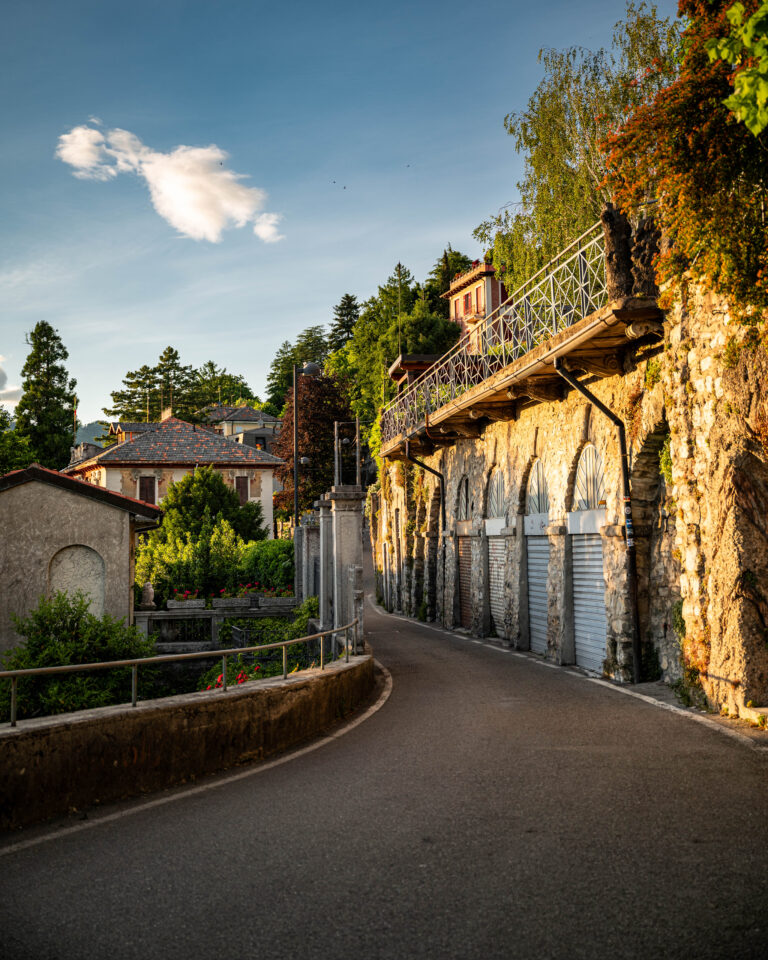 golden light of early evening, this peaceful scene winds through a quiet residential street in Como, on the shores of Lake Como, Italy