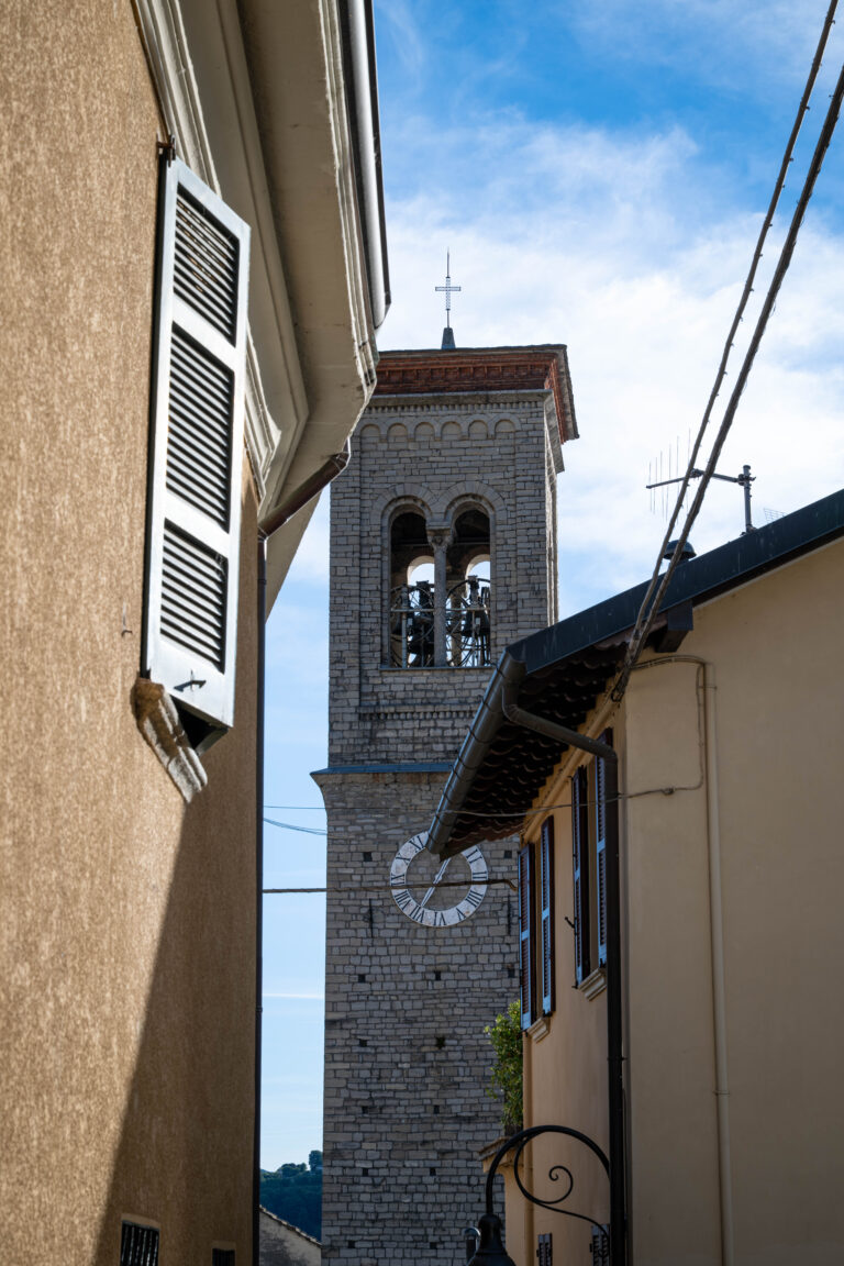 A quiet alley in the village of Torno, on the shores of Lake Como, frames the ancient bell tower of the local church